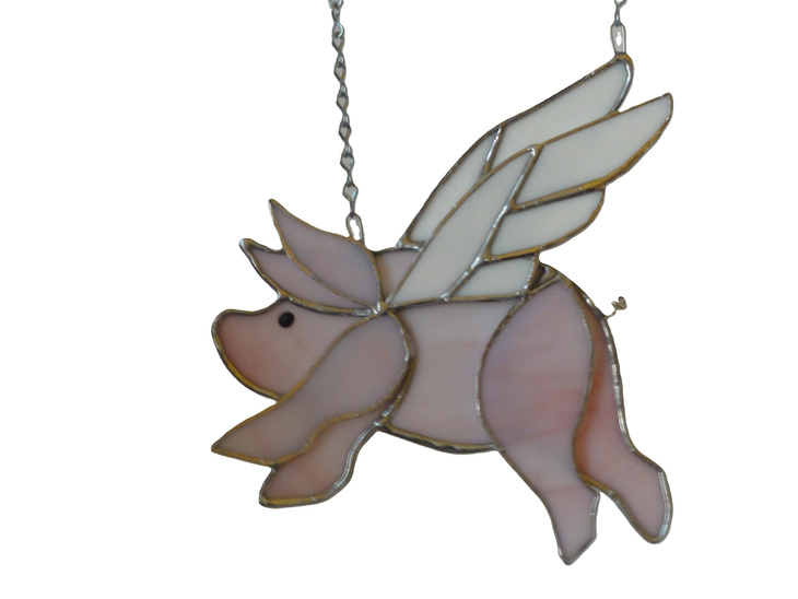 Whimsical flying pig sun catcher with stained glass wings.