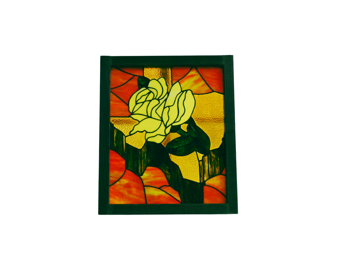 Stained glass panel of a yellow rose on an orange background in a green frame.
